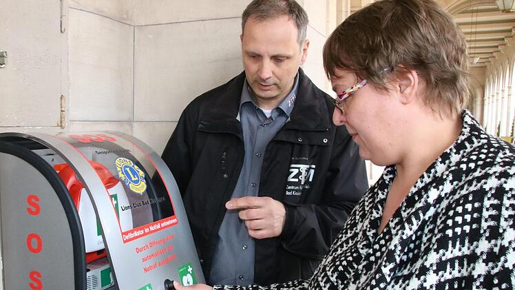 Unter Anleitung von Thomas Schreiner darf Annett Lüdecke das üben, was sonst nur im Notfall erlaubt ist und sofort zum Alarm führt: Den Defi entnehmen. Foto: Ralf Ruppert