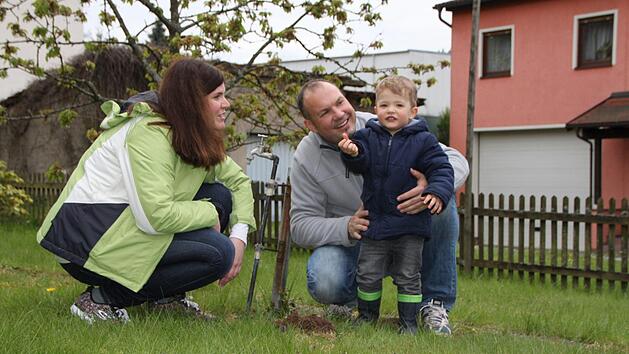 Franziska und Oliver Kaul begutachten mit ihre Sohn Marlon einen frischen Maulwurfshügel in ihrem Garten. Die Familie hat sich mit den kleinen "Mitbewohnern" arrangiert. Foto: Ulrike Müller
