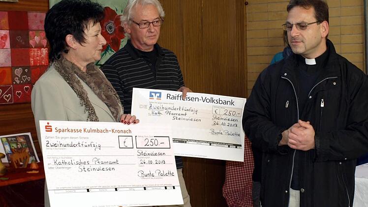 Margrita Baaser und Gerald Simon übergeben die Schecks im Gesamtwert von 500 Euro an Pfarrer Richard F. Reis.