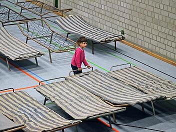 Eines der Kinder, die im Februar in Neustadt aufgenommen wurden, rückt die Betten in der Halle zurecht. Foto: CT-Archiv Rainer Lutz