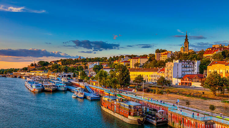Sunset over Belgrade and ships in the harbor. HDR image
