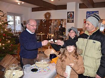 Braumeister Heinz Krause (links) ließ die Besucher des Weihnachtsmarkts in Weißenbrunn testen. Das stärkste Bier der Welt gibt es nur in Likörgläsern - und mit Sahnehäubchen.