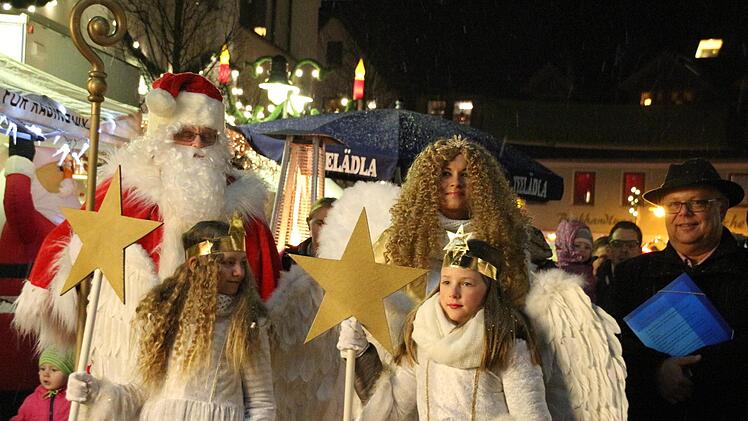 Der Nikolaus und das Christkind mit seinen zwei Engeln führten den Laternenumzug mit Drittem Bürgermeister Martin Stingl (rechts) über den Marktplatz.  Foto: Dominic Buckreus