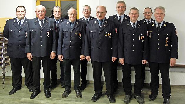Thomas Eidelloth (von links), Gerhard Wilde, Johannes Wachter, Herbert Eisentraudt, Michael Weber, Herbert M&uuml;ller, Heinrich Steiger, Rudi Jaros, Erster Kommandant Michael Jaros und Kreisbrandrat Joachim Ranzenberger haben das Ehrenzeichen in Silbe...