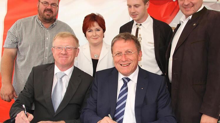 Der Kirchleuser Ortssprecher Richard Ströbel und Oberbürgermeister Henry Schramm besiegeln die Zukunft der Dorfhalle Kirchleus. Auch Pfarrer Christian Schmidt, die stellvertretende Landrätin Christina Flauder, Stadtrat Thorsten Grampp und Stadtrat Ingo Lehmann freuen sich.  Foto: Sonny Adam