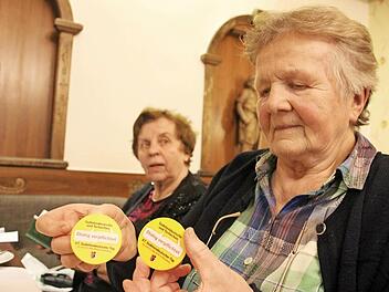 Anneliese Moritz zeigt die Anstecker für den Sudetendeutschentag im Mai. Fotos: Heike Beudert