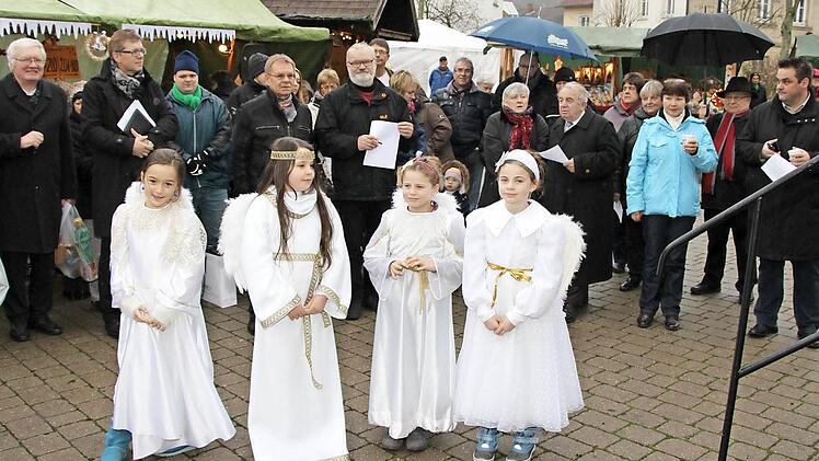 Beim Auftakt zur Dorfweihnacht (hinten von links): Georg Zenk und Martin Gundermann sowie (Bildmitte) Wolfgang Beiergrößlein und Winfried Lebok; (vorne von links) Engel Lina Küfner, Christkind Lanya Fischer und die beiden Engel Klara und Emma Dunst.  Foto: Rainer Glissnik