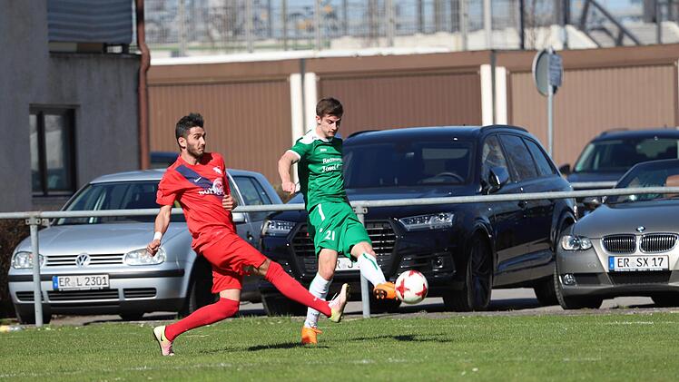 ATSV-Spieler Kevin Guerra (rotes Trikot) kommt gegen Marco Haaf zu spät, so dass dieser flanken kann. Bei der Hereingabe war aber Schlussmann Kraut auf dem Posten.  Foto: Sebastian Baumann