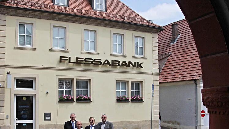 Durch den Torbogen der Rathaushalle auf die Flessabank geblickt. Über deren 50jährigen Bestehen freuen sich (von links): Bankchef Mathias Ritzmann, der ehemalige und der aktuelle Niederlassungsleiter in Ebern, Manfred Geßner und Wolfgang Schreiber, sowie Bürgermeister Jürgen Hennemann. Foto: Helmut WillDurch den Torbogen der Rathaushalle auf die Flessabank geblickt. Über deren 50jährigen Bestehen freuen sich (von links): Bankchef Mathias Ritzmann, der ehemalige und der aktuelle Niederlassungs...