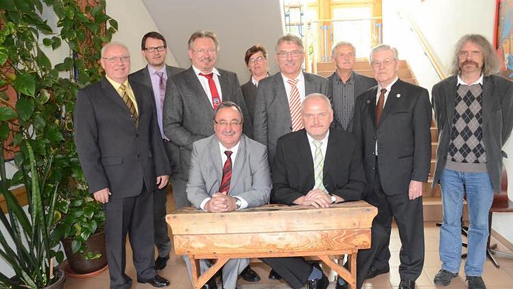 Rektor Reinhard Horn und Stellvertreter Thomas Müller (vorne sitzend, von links) durften wie einst, auf einer alten Schulbank zur Amtseinführung Platz nehmen. Stehend (von links) Rektor a. D. Günther Hanna, Jens Schmidt (Personalrat), Hans Pietz (Bürgermeister und Schulverbandsvorsitzender), Silvia Reier (Elternbeirat), Uwe Dörfer (Schulamtsdirektor), Herbert Vetter (Verbundkoordinator), Josef Wich (Rektor a. D.) und Pater Helmut Haagen.