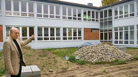 Rektor Friedrich Tasch zeigt auf zugemauerte Fenster und Steinhaufen im Innenhof der Schule. Hier wird ein stählerner Rundlauf eingebaut, ein schneller Fluchtweg für den Notfall, der hoffentlich nie eintritt.