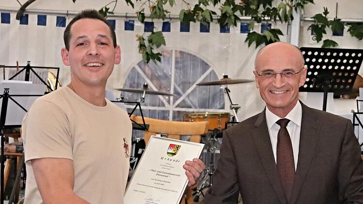 Vorsitzender Martin Schramm (links) nimmt die Glückwünsche von Landrat Wilhelm Schneider entgegen.