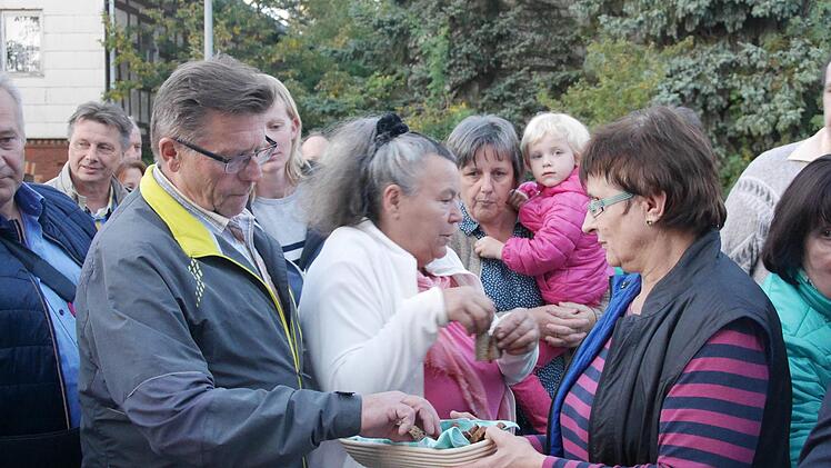 Während der Gottesdienst-Station am Dorfbackofen erhielt jeder Gast ein Stück Brot. Foto: Nelly Ritz