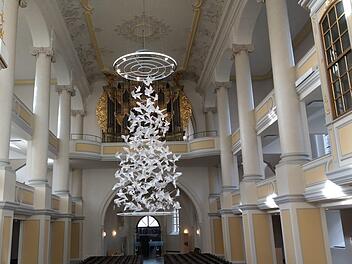 Design oder Kunst? 200 Tauben, aus Papier gefaltet und an Stahlseilen aufgefädelt, bilden den Weihnachtsbaum in der Coburger Kirche St. Moriz. Foto: Simone Bastian