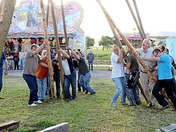 Mit einem gemeinschaftlichen Kraftakt wird der Kirmesbaum aufgestellt. Foto: Peter Rauch/Archiv