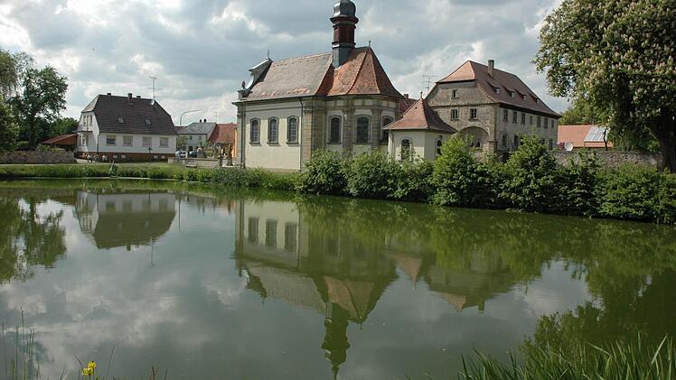 Der Dorfsee in Leuzendorf stellt ein idyllisches Plätzchen dar. Eine Sanierung musste durchgeführt werden, weil die Ufer unterspült waren und die Kirche St. Michael gefährdeten. Hinter der Kirche ist das ehemalige Kapuzinerkloster zu sehen.