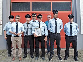 Stolz zeigt der neu ernannte Ehrenkommandant Hans Ott (Vierter von rechts) seine Urkunde. Von links KBM J&ouml;rg Greser, B&uuml;rgermeisterJens Korn, Zweiter Kommandant Andr&eacute; Schuberth, KBI Frank Fischer, Bernd St&ouml;cker, Erster Kommandant Tobias Wolf und Ro...