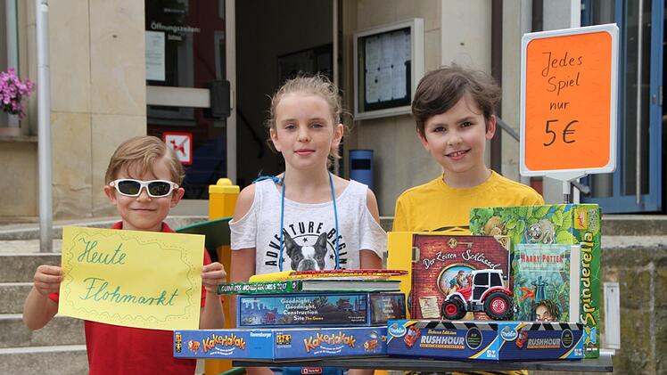 David (von links), Linda und William haben schon mal probeweise einen Stand für den Kinderflohmarkt aufgebaut. Foto: Ulrike Müller