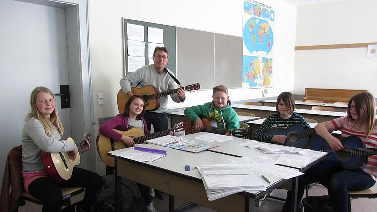Unter der Anleitung von Reiner Babucke können die Schüler im Rahmen des Projekts "Eis" Gitarre lernen. Foto: Kreisjugendring