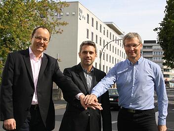 Auf die neuen Büros im Telekom-Gebäude in der Münchner Straße (hinten) freuen sich (von links) Veranstaltungsleiter Bruno Heynen, Kurdirektor Frank Oette und Thomas Lutz vom Kissinger-Sommer-Büro. Foto: Ralf Ruppert
