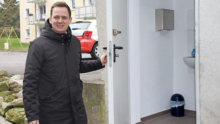 Bad Rodachs Bürgermeister Tobias Ehrlicher (SPD) gibt die sanierte Friedhofstoilette frei. Das Waschbecken und die neuen Fließen verbessern fortan die Hygiene des öffentlichen WC. Foto: Sven Dörr