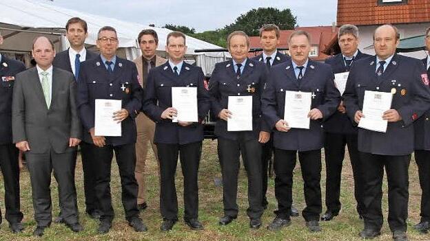 Die geehrten Feuerwehrleute aus der Gemeinde Hallerndorf mit Kreisbrandrat Oliver Flake, den Kreisbrandinspektoren Harald Kraus und Johannes Schmitt, Landrat Hermann Ulm, MdL Michael Hofmann und Bürgermeister Torsten Gunselmann. Foto: Mathias Erlwein