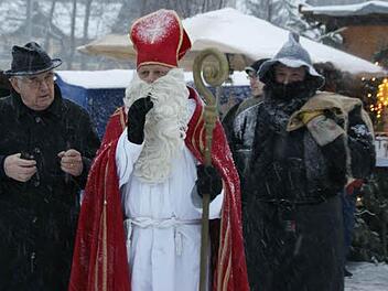Nach 30 Jahren war Werner Burger beim Kirchaicher Adventsmarkt letztmals der Nikolaus; hier ist er in Begleitung von Pfarrer Franz Thoma (links). Foto: sw