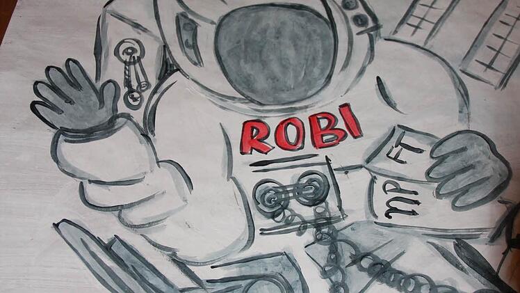 Astronaut Robi nimmt bei seiner Reise ins Weltall auch die tageszeitungen mit.