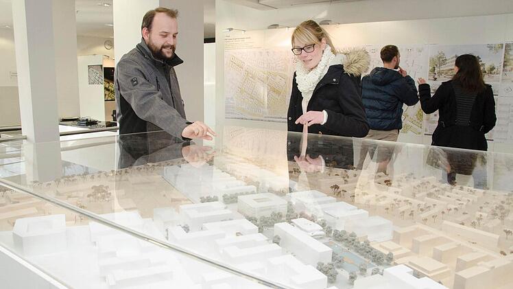 Besucher in der Ausstellung mit den Entwürfen des Architekturwettbewerbs zum Siemens Campus Erlangen Foto: Siemens AG