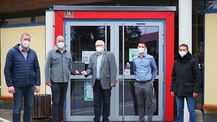 Von links: Bürgermeister Michael Keilich (CSU), Unternehmer Michael Mühlherr, Schulleiter Michael Lege, stellvertretender Schulleiter Stefan  Korth und Louis Kappenberger bei der symbolischen Übergabe der Spende von 60 Tablets vor der Grund- und Mittelschule Sonnefeld.