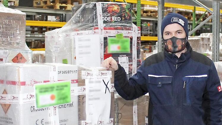Max Schütz, einer der Firmenchefs von Feuerwerk Röder, vor fertig gepackten Bestellungen in der Lagerhalle Foto: Evi Seeger