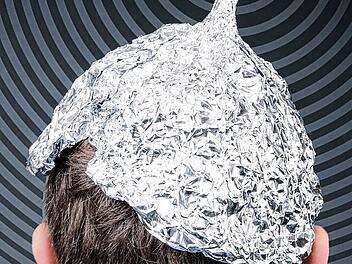 Boy in a tin foil hat from the back