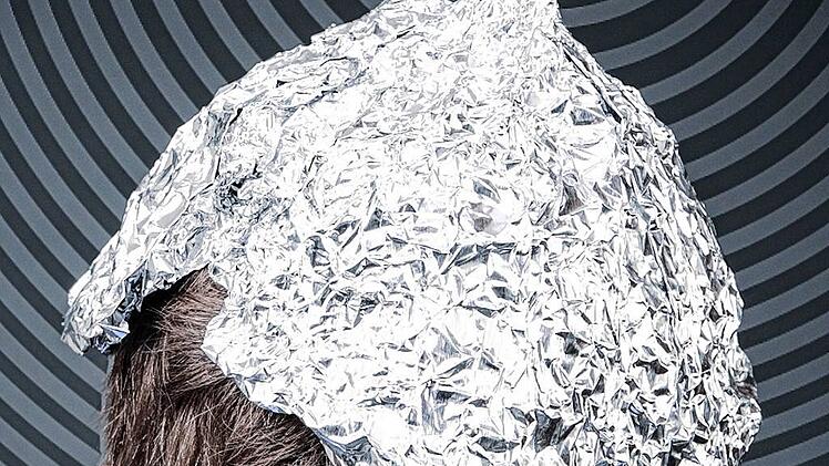 Boy in a tin foil hat from the back