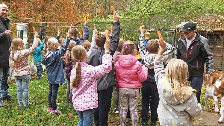 B&uuml;rgermeister Jochen Trier (l.) und Gerd Hofmann (r.) mit den Kindern im Kleintiergehege