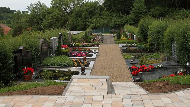 Dreierlei Wegebefestigung sieht man derzeit im Friedhof Neubrunn, wobei die alten Platten (im Hintergrund) auf jeden Fall entfernt werden. Bei einer Besichtigung und Diskussion vor Ort soll heute mit den Grabbesitzern eine Entscheidung gefunden werden. Foto: Günther Geiling