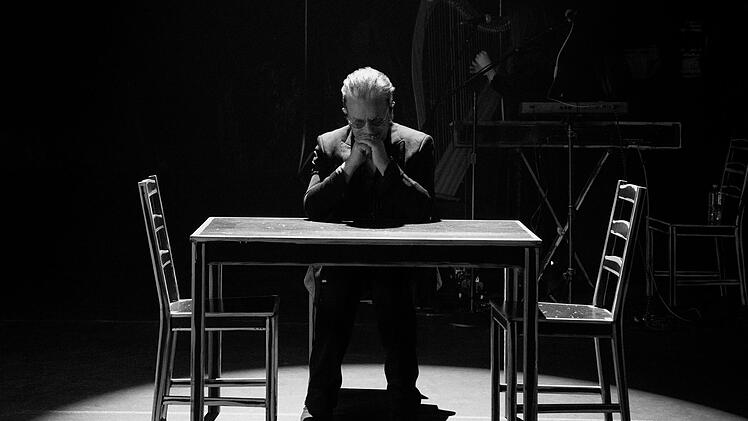 Ein Tisch und drei Stühle reichen: Anders als bei den aufwendigen Bühnenshows mit U2 setzt Bono bei seinen Solo-Auftritten auf Minimalismus.
