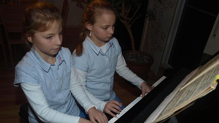 Als kleine Klaviervirtuosen begeistern Lusia (links) und Marie Baier. Die Zwillinge gewannen auf nationaler Ebene in Hof den Wettbewerb "Piano über Grenzen" und qualifizierten sich für das Finale an diesem Wochenende in Karlsbad.  Foto: Stefan Geiger