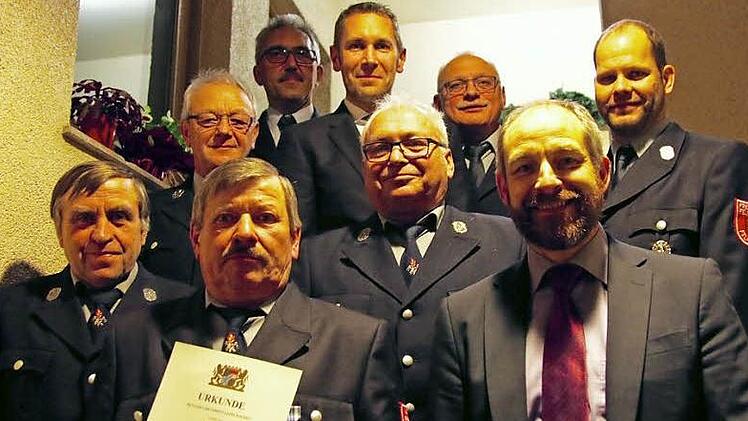 Unser Bild zeigt (von links) Willi Tschesche, Roland Pfaffenberger, Werner Bergmann (mit Urkunde), Kreisbrandinspektor Siegfried Zillig, Bürgermeister Martin Bernreuther, Karl Partenfelder, Vorsitzenden Michael Ganzleben, stellvertretenden Landrat Jörg Kunstmann und Kommandant Robert Nauen.  Foto: Adriane Lochner
