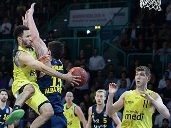 Kyan Anderson hat den Berliner Bogdan Radosavljevic versetzt und legt den Ball für Andreas Seiferth ab. Foto: Peter Mularczyk