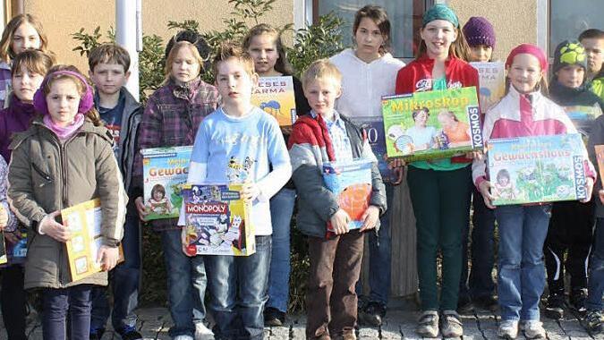 Die Kinder freuen sich über Spiele, die sie für ihre Bilder mit Tier- oder Landschaftsmotiv bekommen haben.  Foto: sw
