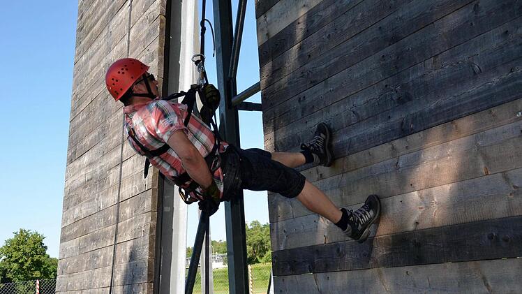 Bauhofmitarbeiter Stefan Schmitt ist der erste, der sich am Kletterturm abseilt. Hier hat er den Abstieg schon fast geschafft. Fotos: Kathrin Kupka-Hahn