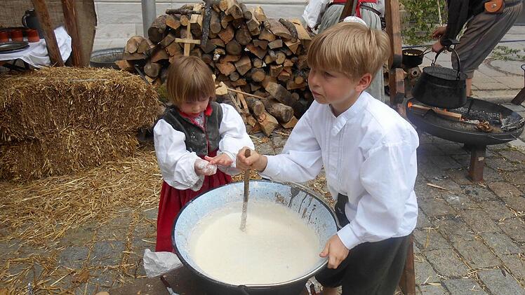Katalin und Oskar rühren den Milchreis für gebackene Milchreis-Bällchen. Foto: privat