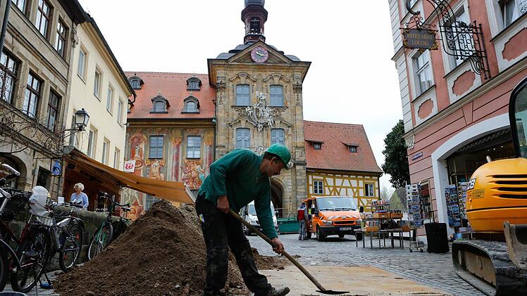 Arbeiter gräbt Leitungen auf.  Foto: Matthias Hoch