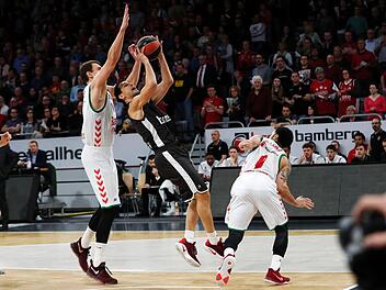 Nikos Zisis von Brose Bamberg will unter dem Korb abschließen, aber der Wahl-Spanier Johannes Voigtmann (l.) lauert schon auf den Block; rechts Shane Larkin. Fotos: Daniel Löb