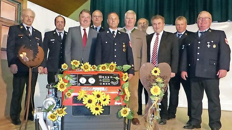 Kreisbrandinspektor Horst Tempel, Kreisbrandmeister Alexander Reinsch, Landrat Klaus Peter Söllner, Kreisbrandrat Stefan Härtlein, Kommandant Oliver Schott, MdL Ludwig von Lerchenfeld, Pater Joseph, Bürgermeister Siegfried Beyer, Zweiter Kommandant Reiner Lauterbach und Vorsitzender Thomas Gareis (von links) freuen sich über die neue Pumpe.  Foto: Klaus-Peter Wulf