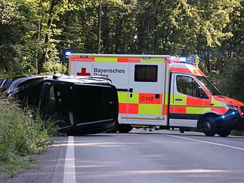 Der Rettungsdienst kümmerte sich um die Unfallbeteiligten nach dem Unfall auf der B287 zwischen Bad Kissingen und Nüdlingen. Davor der auf der Seite liegende Wagen des Unfallverursachers. Foto: Benedikt Borst