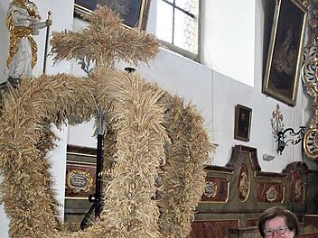 Rita Simon neben der Erntekrone in der Buttenheimer Pfarrkirche St. Bartholom&auml;us. Beim Schm&uuml;cken ist sie jedes Jahr immer gerne dabei.