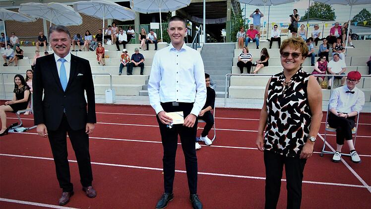 Landrat Klaus Peter Söllner (links) überreichte an den Schulbesten des Abschlussjahrganges 2020, Paul Schwabenland, den Landkreispreis. Rechts Realschuldirektorin Monika Hild. Die Ehrung und Verabschiedung fand auf dem Sportgelände statt. Fotos: Werner Reißaus