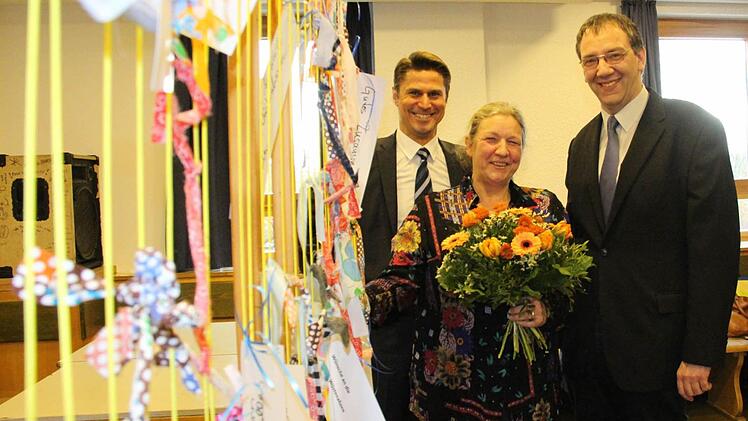 Quartiersmanagerin Brigitte Lambert nimmt vor einem "Netz der guten Wünsche" Abschied aus Wüstenahorn. Wohnbau-Geschäftsführer Christian Meyer (links) und die Kirchengemeinde Johanneskirche (rechts Kirchenvorstand Thomas Nowak) werden die Arbeit in der "Sozialen Stadt" so gut es geht fortsetzen.  Fotos: Simone Bastian