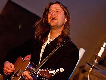 Liedermacher mit christlicher Botschaft und einem Faible für Kerzenleuchter: Andy Lang gastiert in der Coburger Morizkirche. Foto: Jochen Berger